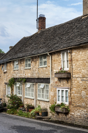 Quaint Cotswold romantic stone cottages on The Hill, in the lovely Burford village, Cotswolds, Oxfordshireのeditorial素材