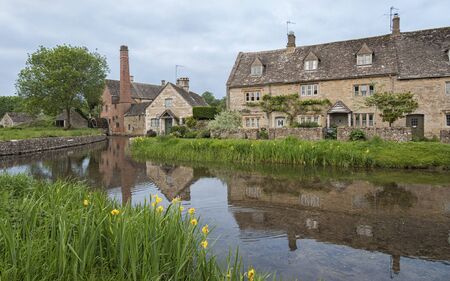 LOWER SLAUGHTER, COTSWOLDS, GLOUCESTERSHIRE, ENGLAND - MAY, 27 2018: The Old Mill along the River...
