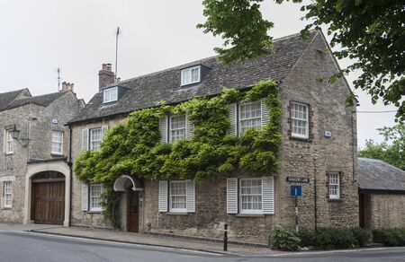 WOODSTOCK, UK - MAY 28, 2018: Wisteria on Thomas Chaucer's House & servants' Cottage in the small...
