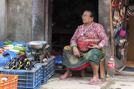 BHAKTAPUR, NEPAL AUGUST 13, 2018: Unidentified Nepalese woman selling vegetables in Bhaktapur, Nepalのeditorial素材