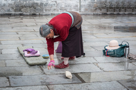 LHASA, TIBET, CHINA - AUGUST, 17 2018: Pilgrims in front of Jokhang temple. The Buddhist Temple in Barkhor Square is considered the most sacred and important temple in Tibet.のeditorial素材