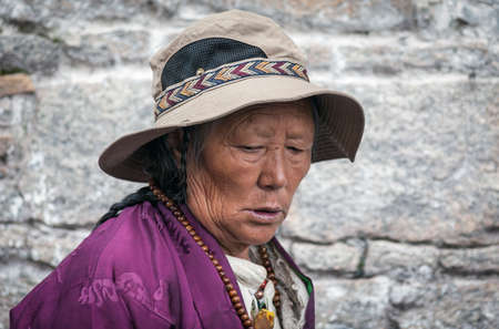 LHASA, TIBET, CHINA - AUGUST, 17 2018: Unidentified Tibetan pilgrim with with typical clothing near...