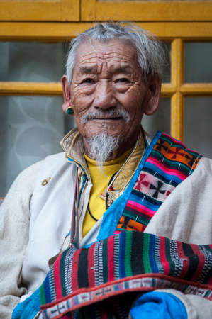 LHASA, TIBET - AUGUST 18, 2018: Tibetan Pilgrim inside the Jokhang Temple in Lhasa, Tibet. It is one of the famous Buddhist monasteries in Lhasaのeditorial素材