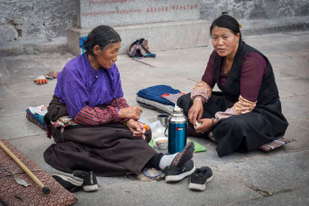 LHASA, TIBET, CHINA - AUGUST, 18 2018: Pilgrims in front of Jokhang temple. The Buddhist Temple in Barkhor Square is considered the most sacred and important temple in Tibet.のeditorial素材