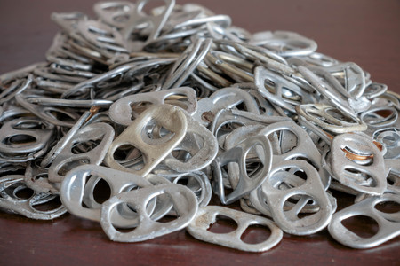 used aluminum can openers on wooden tableの写真素材