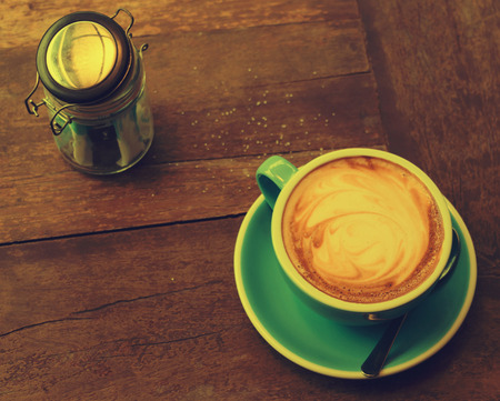 blue cup of coffee on wooden table represent warm feeling in the morningの写真素材