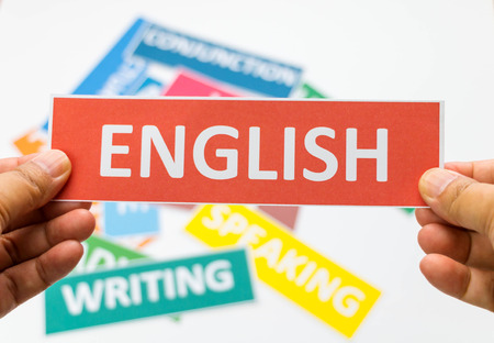 hand holding red english card over other colourful cards on white board represent active study english grammarの写真素材