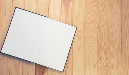 open notebook on brown wooden table for background, the blank space on the right for text