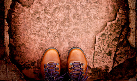 top view boots on stoned pathway show adventure sign with copyspaceの写真素材