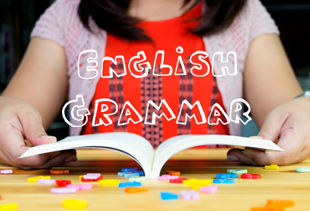 drawing english words fly above open book represents learning Englishの写真素材