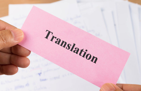 hand holding translation pink card over blur document