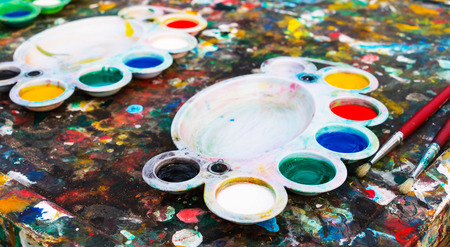 color filled plastic palettes on colorful tableの写真素材