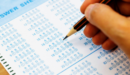 blue answer sheet with pencil on tableの写真素材