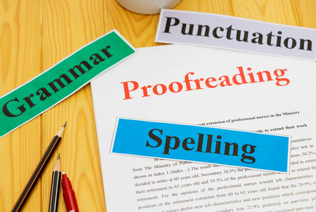 proofreading paper on table with office suppliesの写真素材