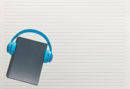 book and headphone over white paper lineの写真素材