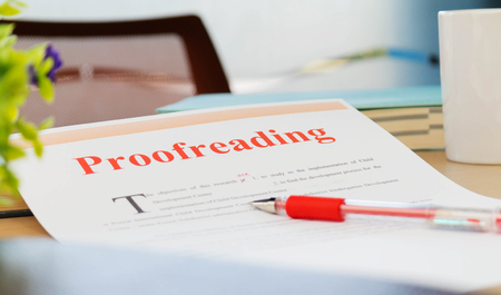 proofreading paper on table in office