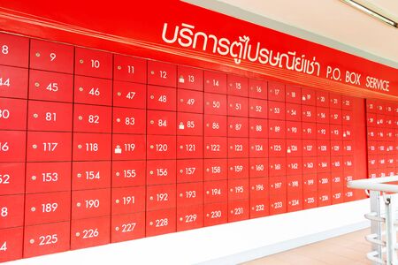 row of red mailbox with white number for serviceの写真素材