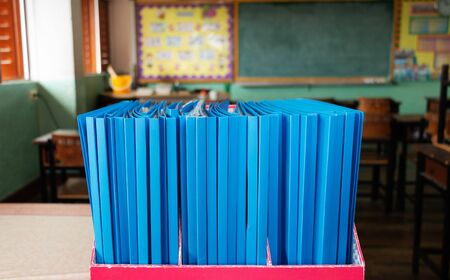 blue portfolio in red box on table in elementary clssrommの写真素材