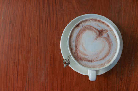 top view of isolated cup of hot coffee on wooden tableの写真素材