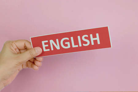 hand holding colorful sign of English learning skills over colorful wallの写真素材