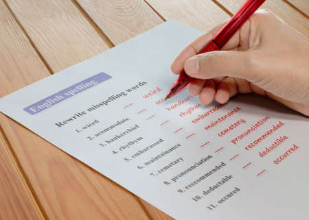 English spelling worksheet on wooden tableの写真素材