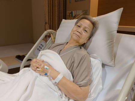 NAKHON RATCHASIMA, THAILAND- July 4, 2021: senior asian woman lying in bed in hospital for recovering her healthの写真素材
