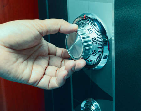 hand turning code number on safe box for securityの写真素材
