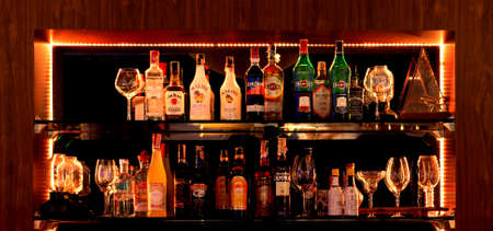 Nakhon Ratchasima, THAILAND- November 26, 2021: bottles of liqour on shelf in bar at nightのeditorial素材