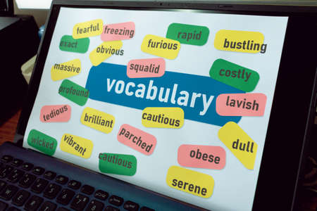 various colorful English vocabulary on laptop screen for studying in online classの写真素材