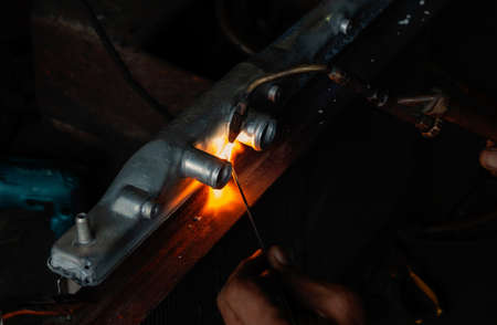 flame of welding steel spark in the dark by technician
