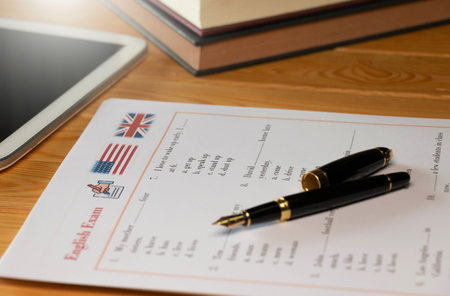 English test with pen on wooden table in class for school testing conceptの写真素材