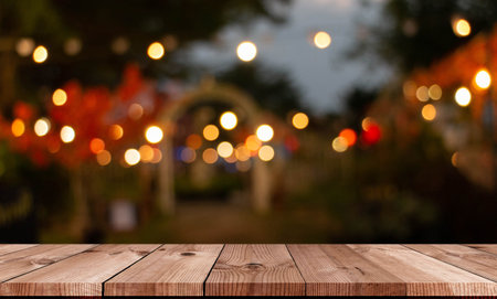 perspective wooden board over bokeh and blurred garden of restaurant at nightの写真素材