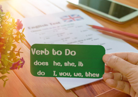 English grammar test on wooden table in classroom