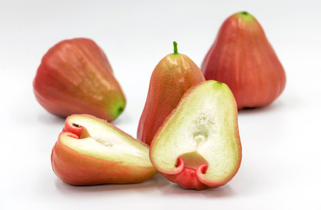 isolated fresh raw red rose apples standing on white background