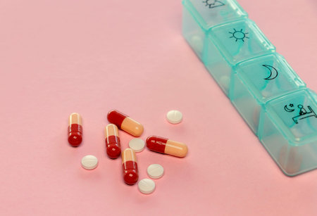 blue  pill set box and capsules on table for daily medication  conceptの写真素材