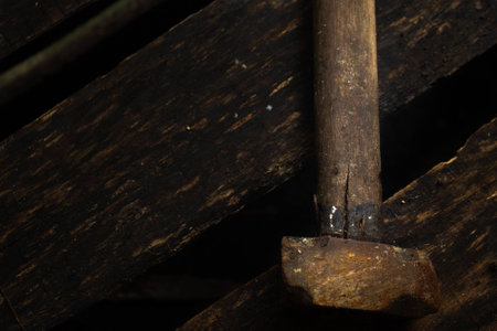 Rusty vintage  hammer on wet black wood background cinematic lookの写真素材