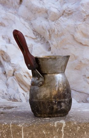 Coffee maker being at a stone wallの写真素材