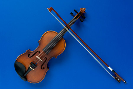 Violin and bow on a blue backgroundの写真素材