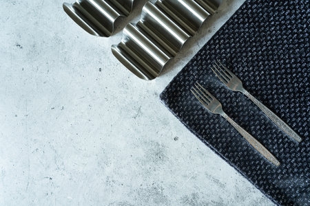 Forks with a shiny napkin on a white marble backgroundの写真素材