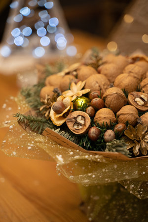 Christmas bouquet of walnuts, hazelnuts and forks of the Christmas tree on the background of lanternsの写真素材