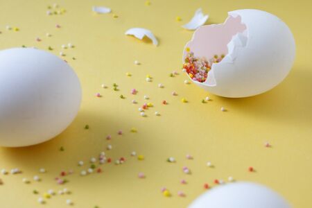 Easter eggs on yellow background with colourful pastry topping. festive easter holiday decorations