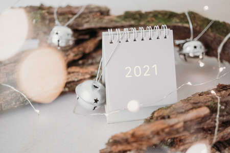New Year 2021 grey calendar with lights in rustic natural style with tree bark
