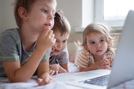 Little kids having video chat via laptop at home lifestyleの写真素材