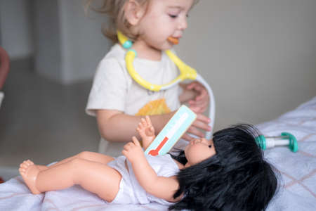 Toddler girl playing a doctor role gameの写真素材