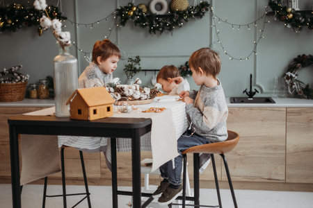 Little preschool kids decorating christmas cookies in decorated homeの写真素材