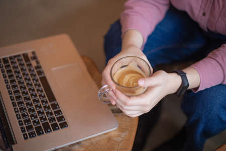 Young caucasian woman working via laptop at the cafeteriaの写真素材