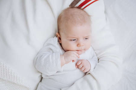 Father laying on the bed with his little infant baby. Family together at home. Single dad. Parental...