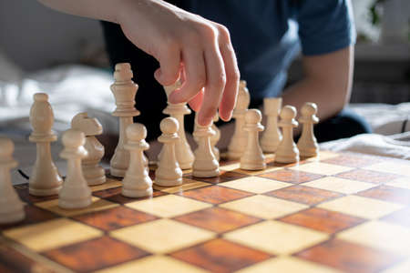 Close up of kids hand playing chessの写真素材