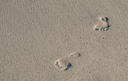 Two woman footsteps in a fine sand.
