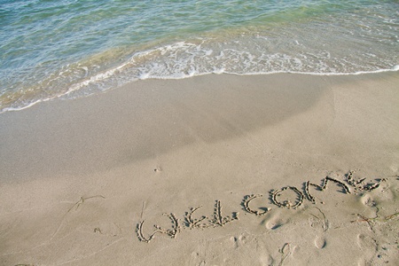 Welcome notice written on the sand.の写真素材